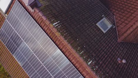 Solar-panels-on-home-rooftop-in-suburbs-of-Riga,-aerial-view