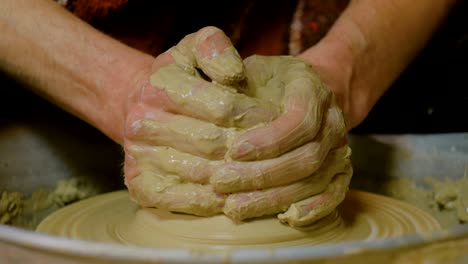 professional male potter making ceramics in workshop