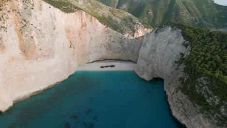white cliffs, turquoise waters, and a shipwreck on a secluded beach in zante, greece