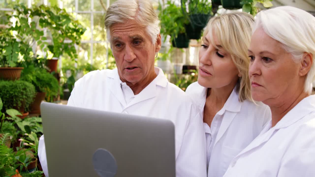 Scientists having discussion on laptop