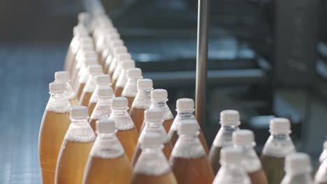 conveyor belt with bottles for juice or water at a modern beverage plant. modern production of sweet soda water