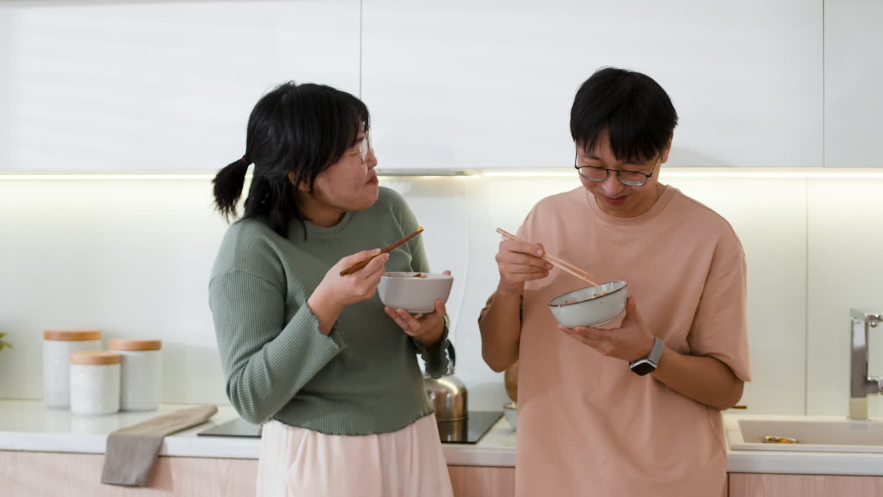 Couple Eating Dinner in Modern Kitchen