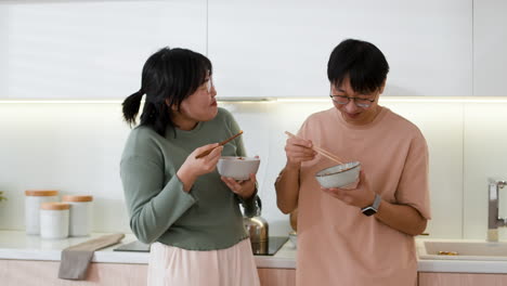 couple eating dinner in modern kitchen