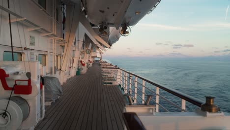 open wooden deck on board of a luxury cruise ship sailing cruising through the ocean sea