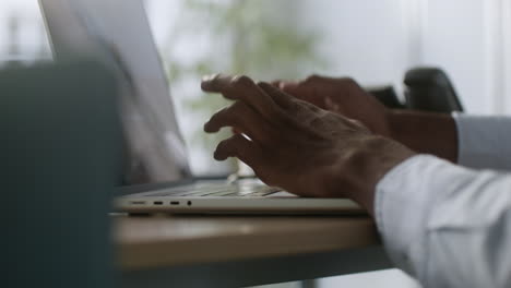 man typing on the laptop