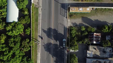 drone video from a bird's eye view capturing the road of bani dominican republic with little traffic, sunset with vivid colors