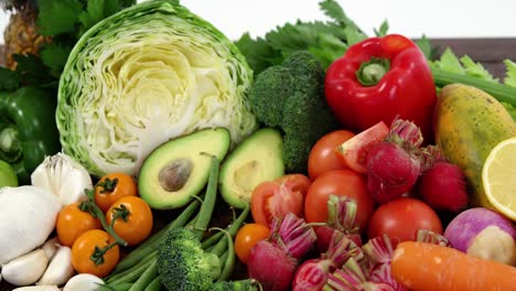 Variety-of-fresh-colored-vegetables-and-fruits-on-wooden-table