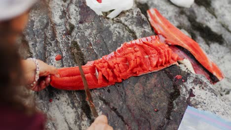 cutting, cleaning, and gutting a wild salmon with a knife