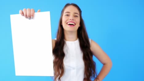 beautiful woman holding blank placard on blue background