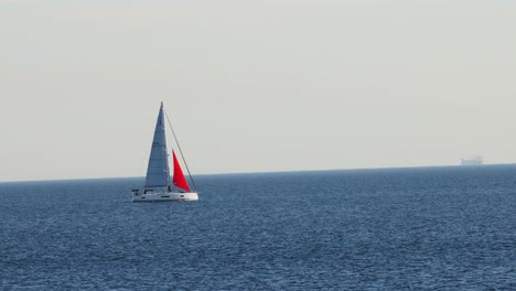 sailboat gliding across calm sea at brighton beach