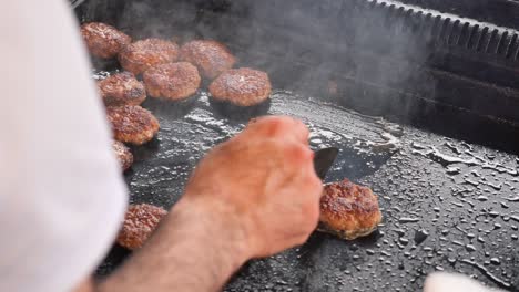 chef preparing turkish meatballs on a grill