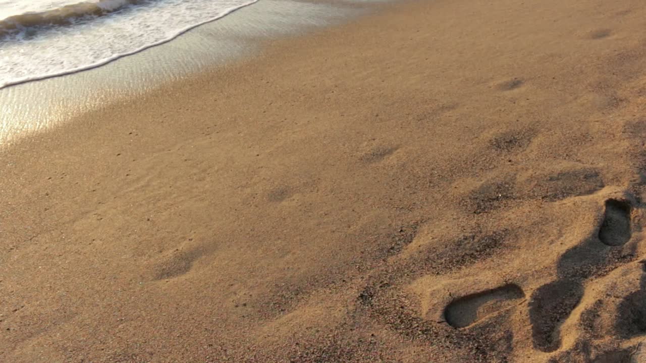 Ocean waves over sandy beach in Mexico holiday destination