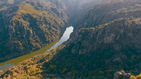 a drone video captures stunning views of mountainous landscapes with a river flowing through the heart of nature