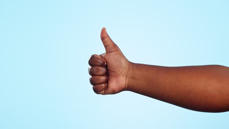 hands, closeup and person with thumbs up in studio