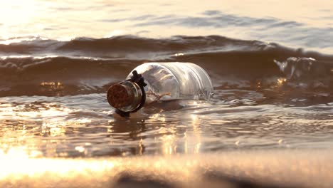 message in the bottle against the sun setting down