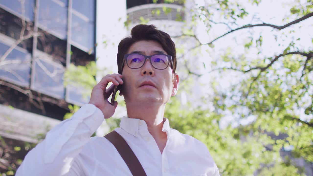 Man holding phone to ear, speaking and checking signal as incoming business chat icons appearing