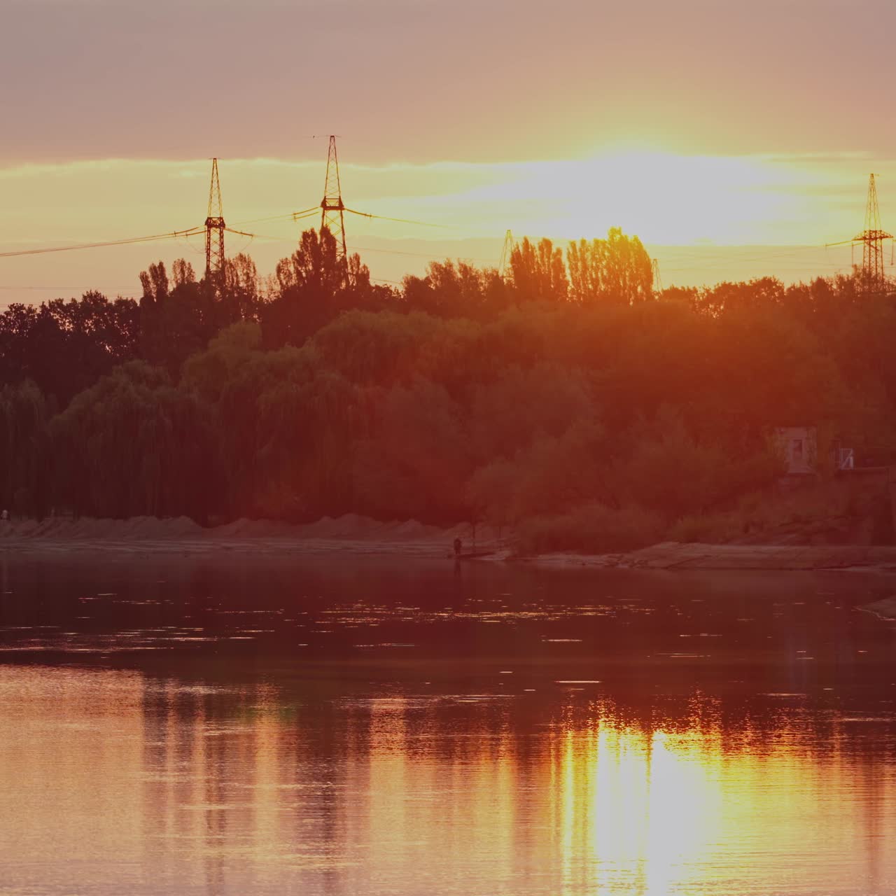 Beautiful sunset above trees and river. Evening sky reflection on water. Countryside scene. Rural landscape