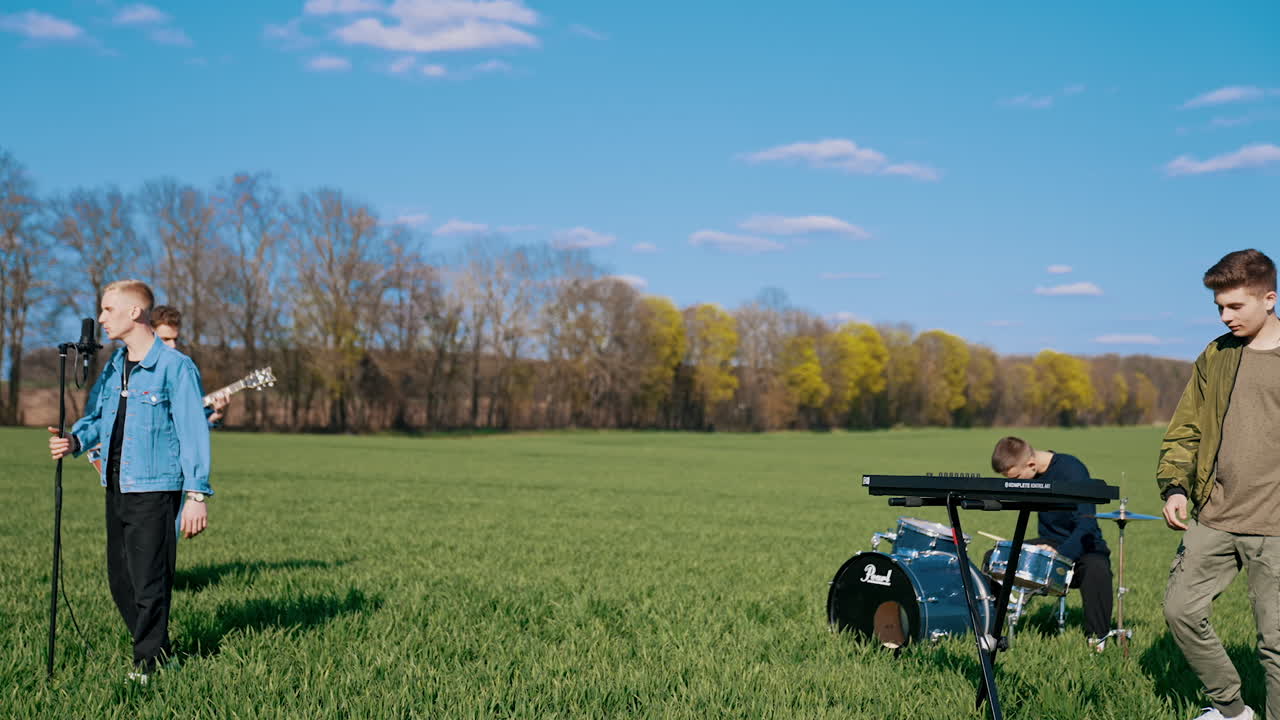 Musical group in field. Musical band playing festival concert on field