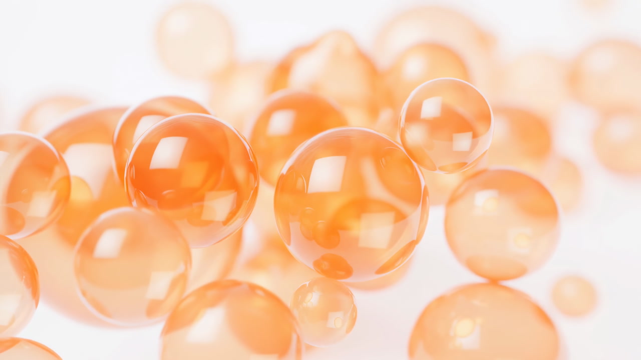 Close-up of Orange Translucent Spheres on White Background