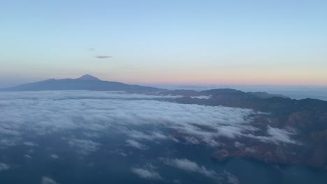 arriving to tenerife island from a cockpit in the dawn with teide volcano in sight