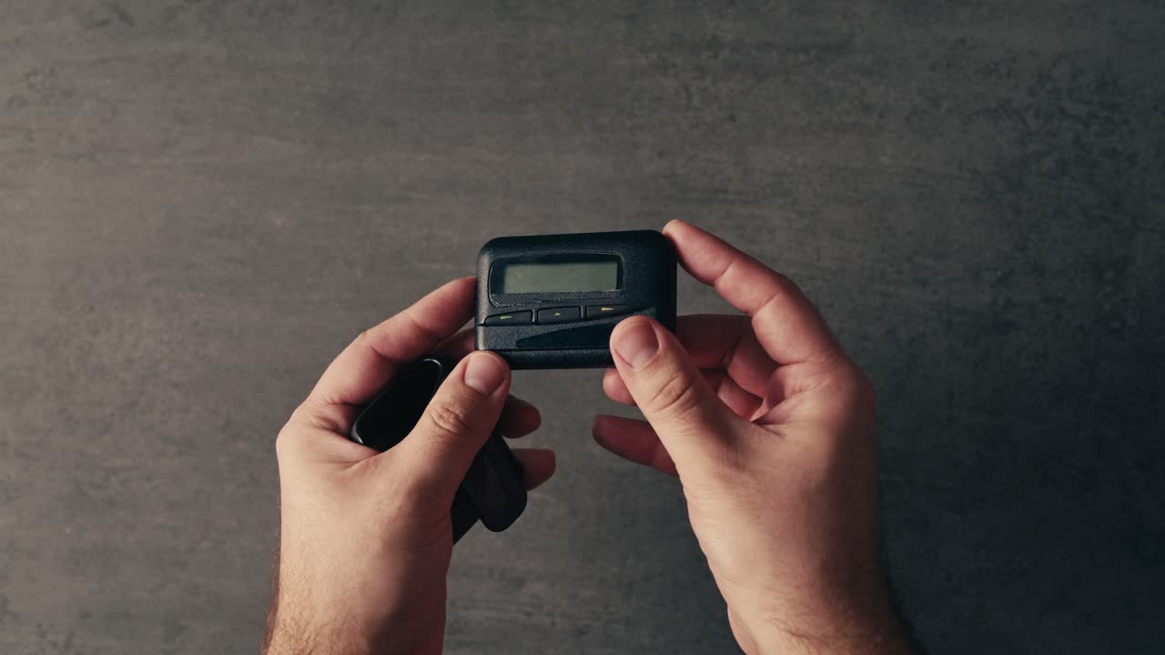 Man Holding a Pager