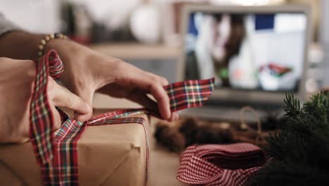 close up video of man's hands packing christmas present