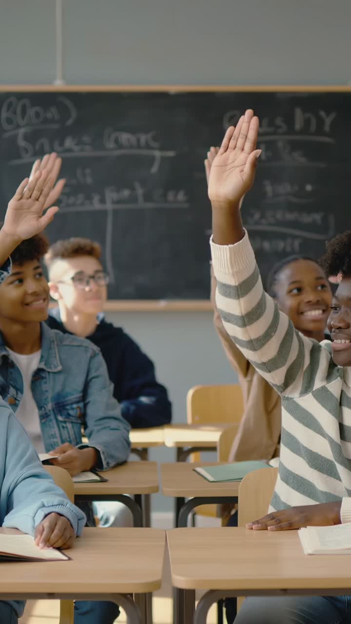 Vertical video: Raising student in striped top by chalkboard on teacher cue, lifting hand to answer