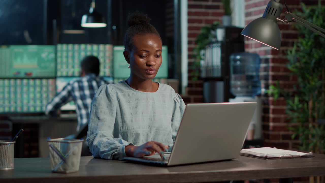 Female broker analyzing stock market exchange on laptop