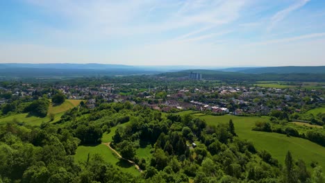 4k aerial drone video of the village below the historic bamberg castle on the edge of bamberg, germany on a beautiful spring day