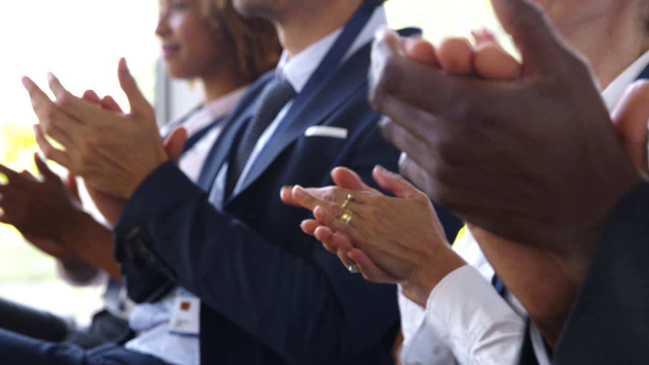 Close Up Of Delegates At Business Conference Applauding Speaker
