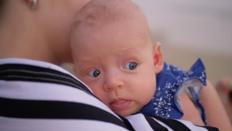 mother with baby receiving video call on cell