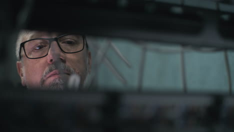 close-up reflection of a man with glasses and beard