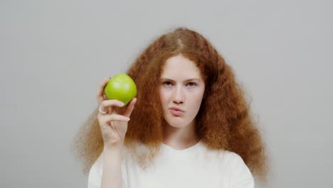 teenage girl holding a green apple