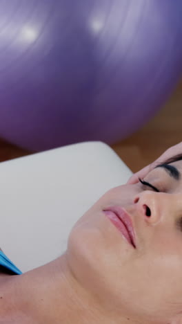 female patient receiving head massage from physiotherapist