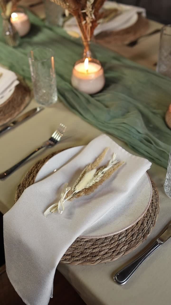 Elegant Dining Table Setting with Dried Flowers and Lit Candles