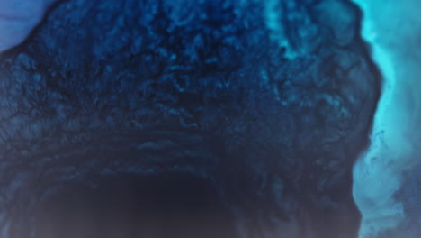blue ink swirling underwater creating mesmerizing patterns, illuminated with blue light