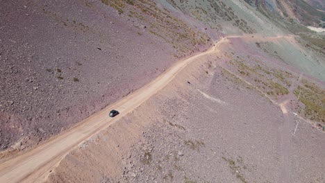 Aerial-View-Of-Cars-Traveling-On-Dirt-Road-Near-Termas-Valle-de-Colina-In-Chile