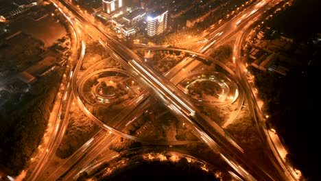 hyper lapse of aerial view of highway junctions with roundabout. bridge roads shape circle in structure of architecture and transportation concept. top view. urban city, shanghai at night, china.