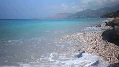 Mediterranean-Empty-Shores-with-Wild-Cliffs,-Azure-Sea,-and-the-Tranquil-Pebble-Beach