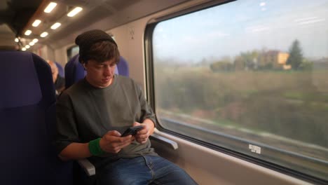 man using a phone on a train