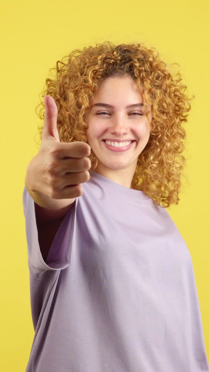 Happy Woman with Curly Hair Giving Thumbs Up
