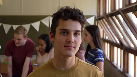 portrait of teenage boy in school classroom