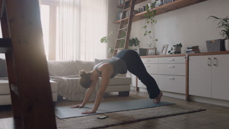healthy-yoga-woman-exercising-at-home-practicing-downward-facing-dog-pose-in-living-room-enjoying-morning-fitness-workout