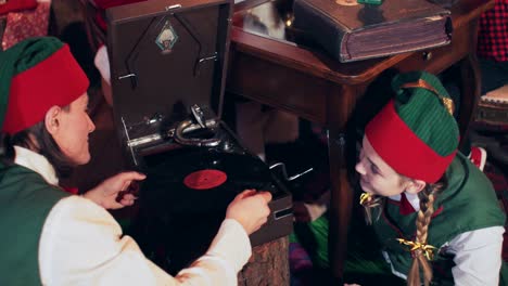 an elf girl in a green suit gives a vinyl record to an elf. dwarves are listening to an old gramophone