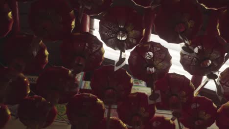red lanterns on ceiling with yin yang symbol in the middle.