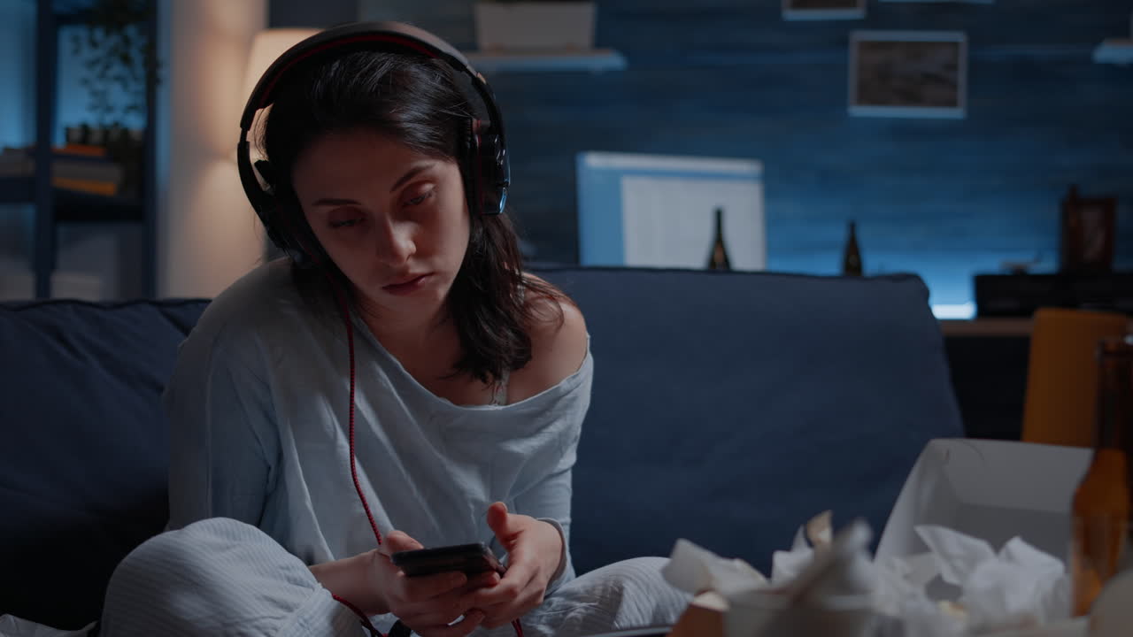 Stressed, depressed woman listening music at phone