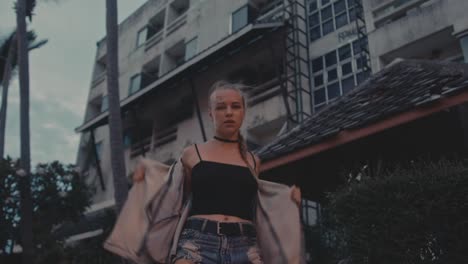 young woman dancing in urban setting