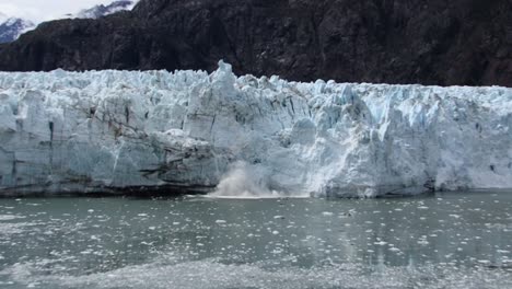 margerie glacier calving with huge piece of ice falling, glacier bay national park - preserve, southeast alaska