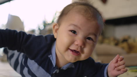 cute infant baby doing tummy time on play mat