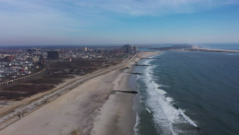 A-high-angle-view-of-an-empty-beach-on-a-beautiful-day-with-a-few-clouds